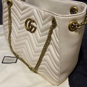 This Gucci tote is beautiful. White ivory, leather with gold double locking Gs